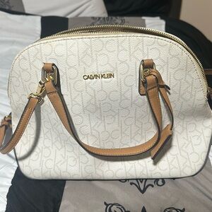 Cross body Calvin Klein bag that’s white and tan.